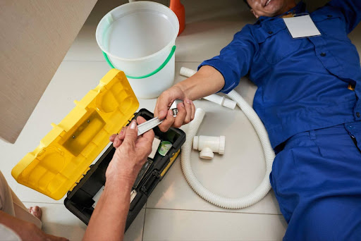 plumber checking under the sink